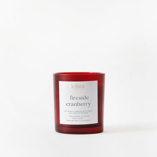 Red candle labeled 'fireside cranberry' on a white background