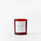 Red candle with a label on a white background